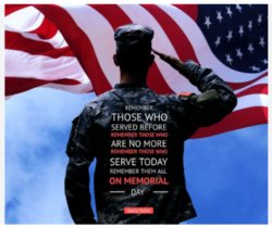 Image of a marine in camouflage saluting the US flag with the following words emblazoned on his back: Remember those who served before. Remember those who are no more. Remember those who serve today. Remember them all on Memorial Day.